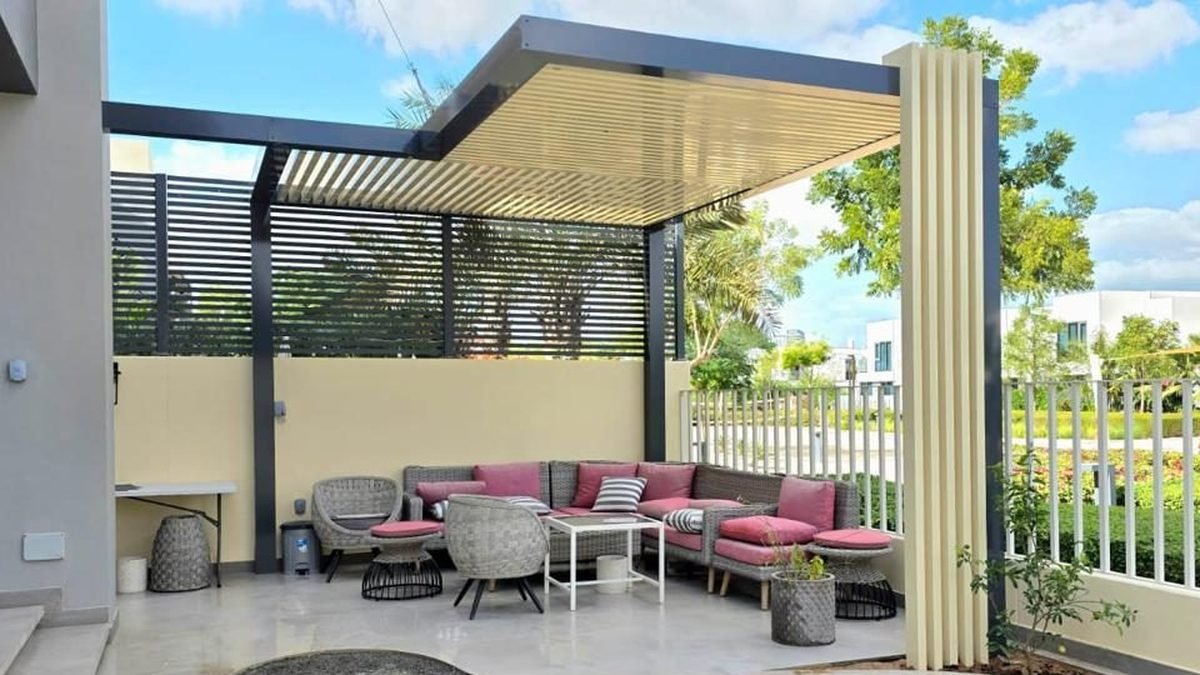 Louvered aluminium pergola over an outdoor lounge at a Dubai villa